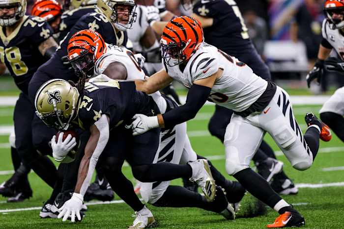 Oct 16, 2022; New Orleans, Louisiana, USA; New Orleans Saints running back Alvin Kamara (41) is tackled by Cincinnati Bengals defensive tackle Zach Carter and linebacker Logan WIlson during the first half at Caesars Superdome. Mandatory Credit: Stephen Lew-USA TODAY Sports